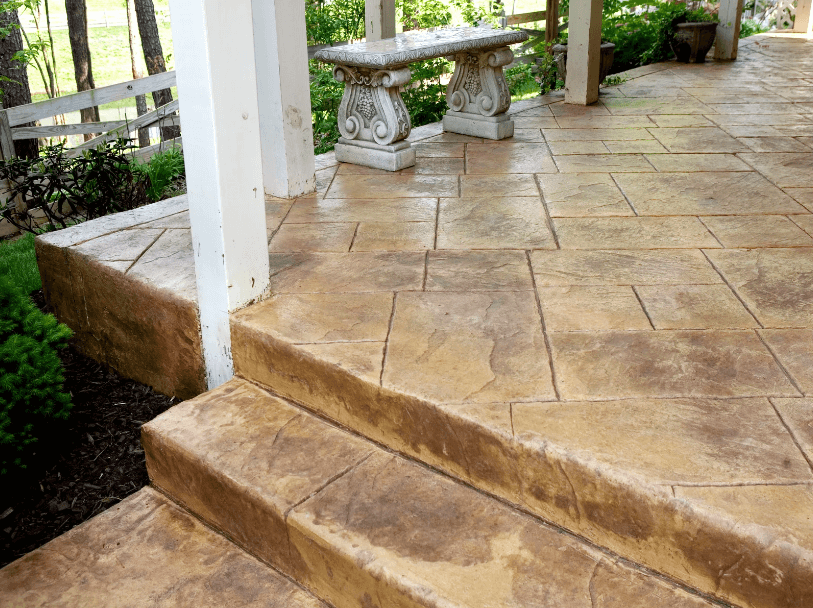 Beige Stamped concrete patio with decorative bench